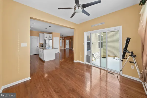 a view of a livingroom with wooden floor and furniture