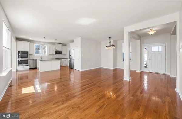 a view of a kitchen with cabinets and wooden floor