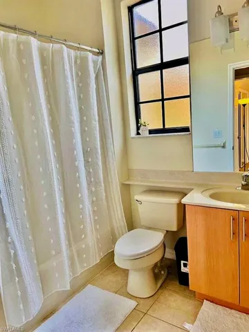 a bathroom with a toilet a sink and a window
