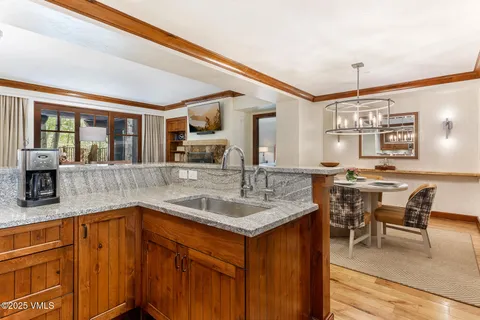 a kitchen with a sink stove and table