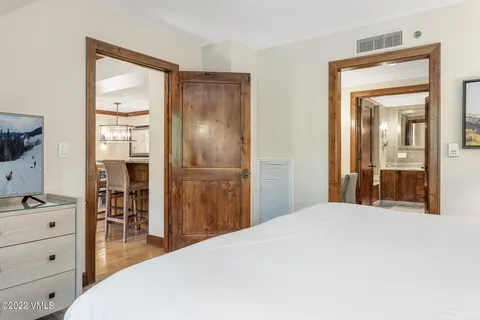 a bedroom with a bed and a mirror