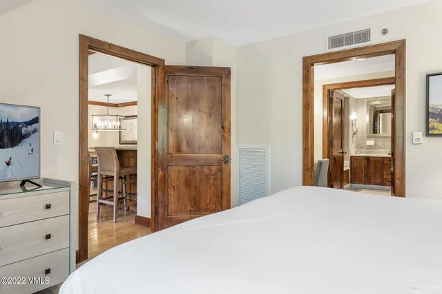 a bedroom with a bed and a mirror