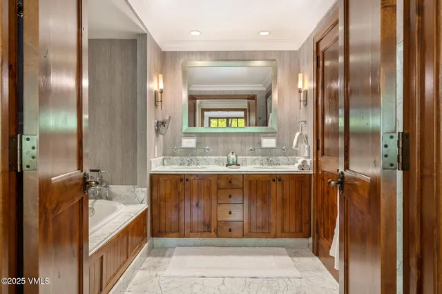 a bathroom with a double vanity sink a mirror and a shower