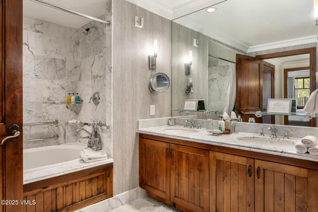 a bathroom with a granite countertop sink mirror and shower