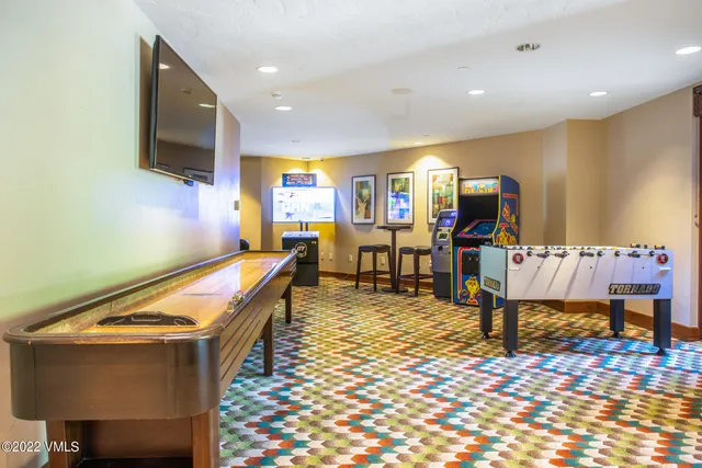 a room with pool table and flat screen tv
