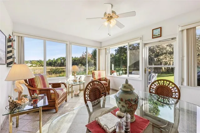 a living room with furniture and floor to ceiling windows