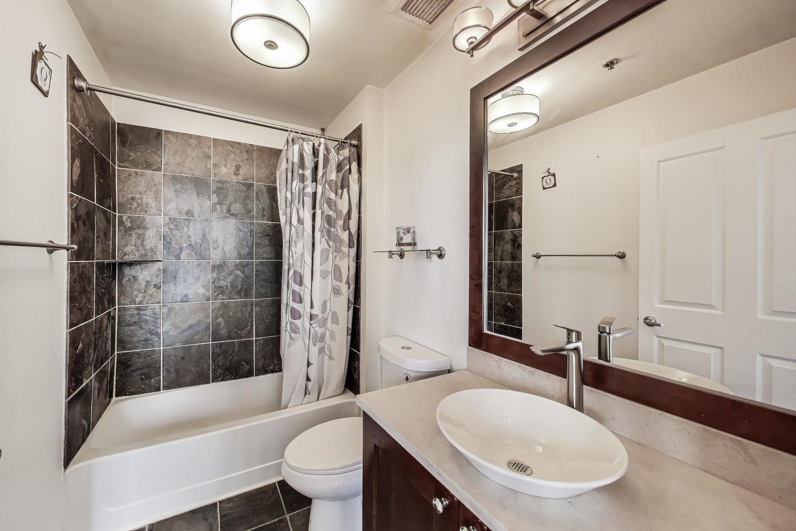 1464 South Michigan Avenue, Unit 1609 Chicago, IL 60605 - Photo 35 of 45 a bathroom with a sink a toilet and a bathtub