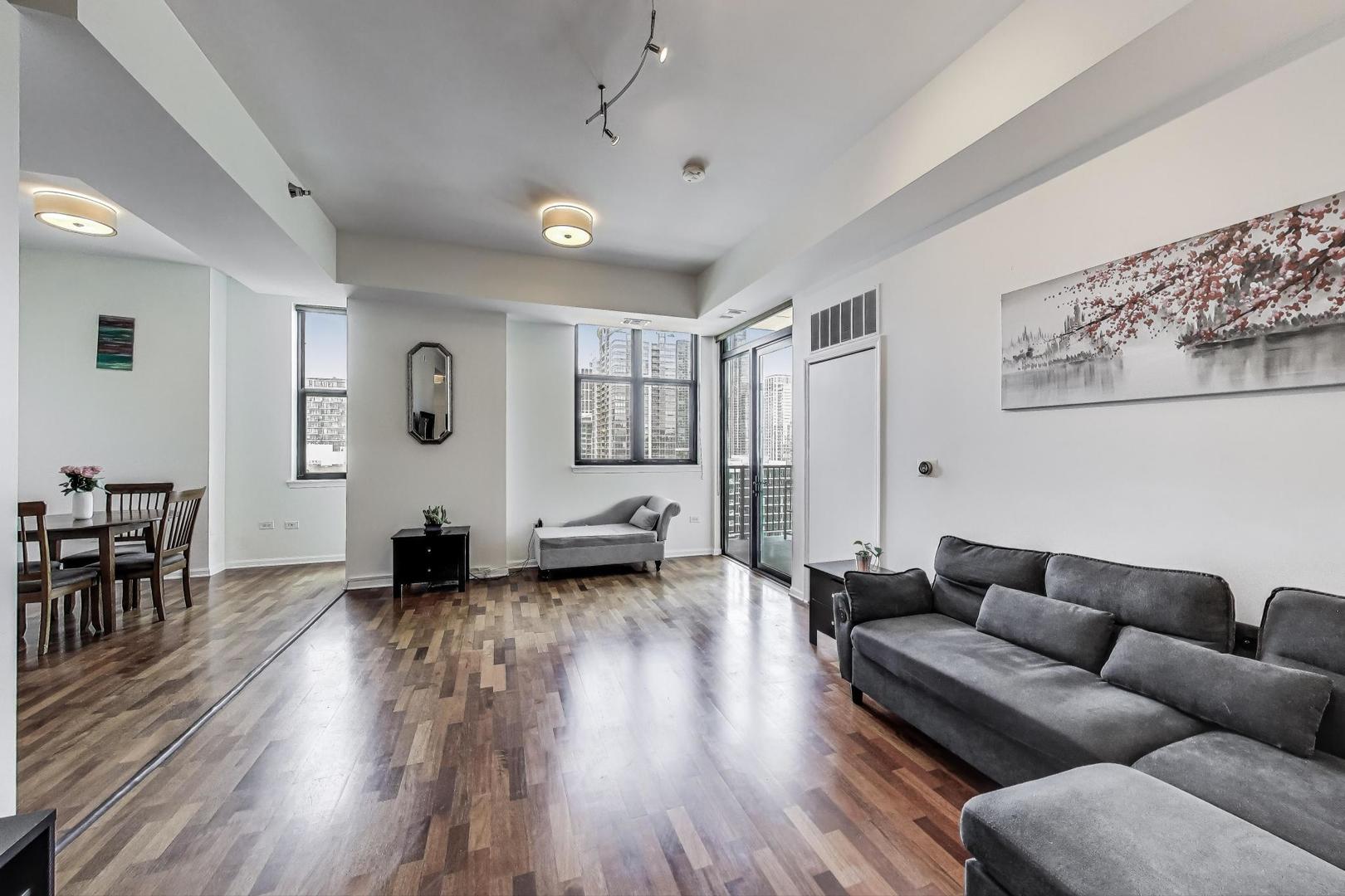 1464 South Michigan Avenue, Unit 1609 Chicago, IL 60605 - Photo 4 of 45 a living room with furniture and wooden floor