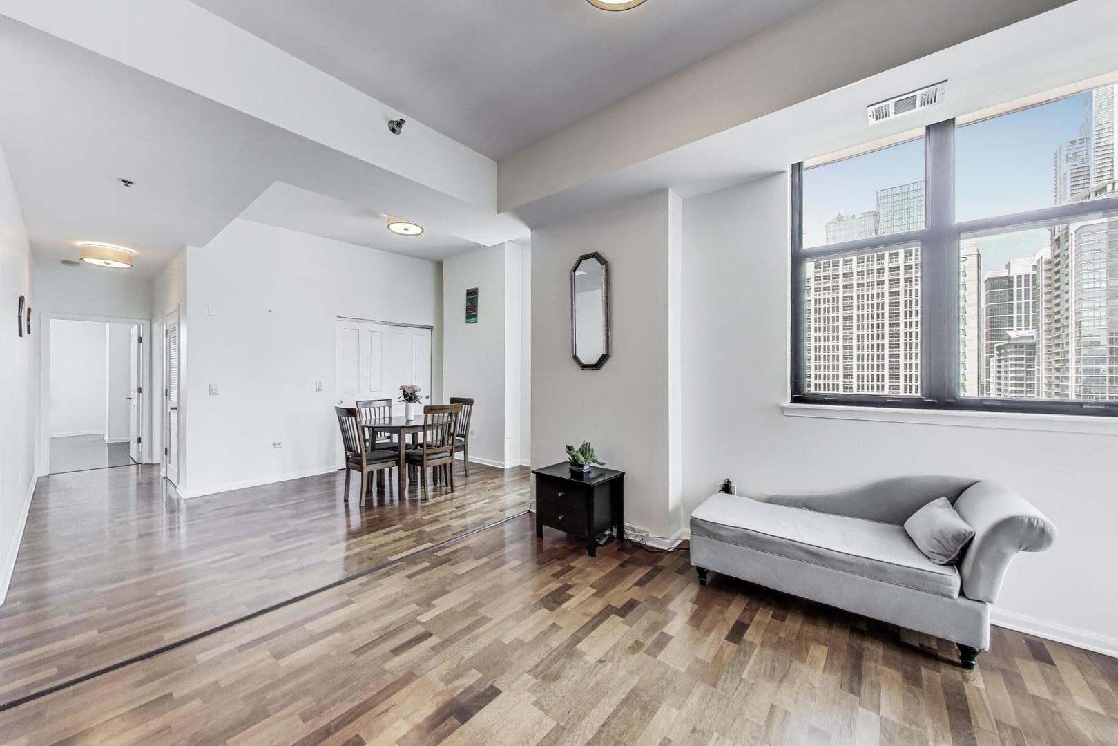 1464 South Michigan Avenue, Unit 1609 Chicago, IL 60605 - Photo 6 of 45 a living room with furniture and wooden floor