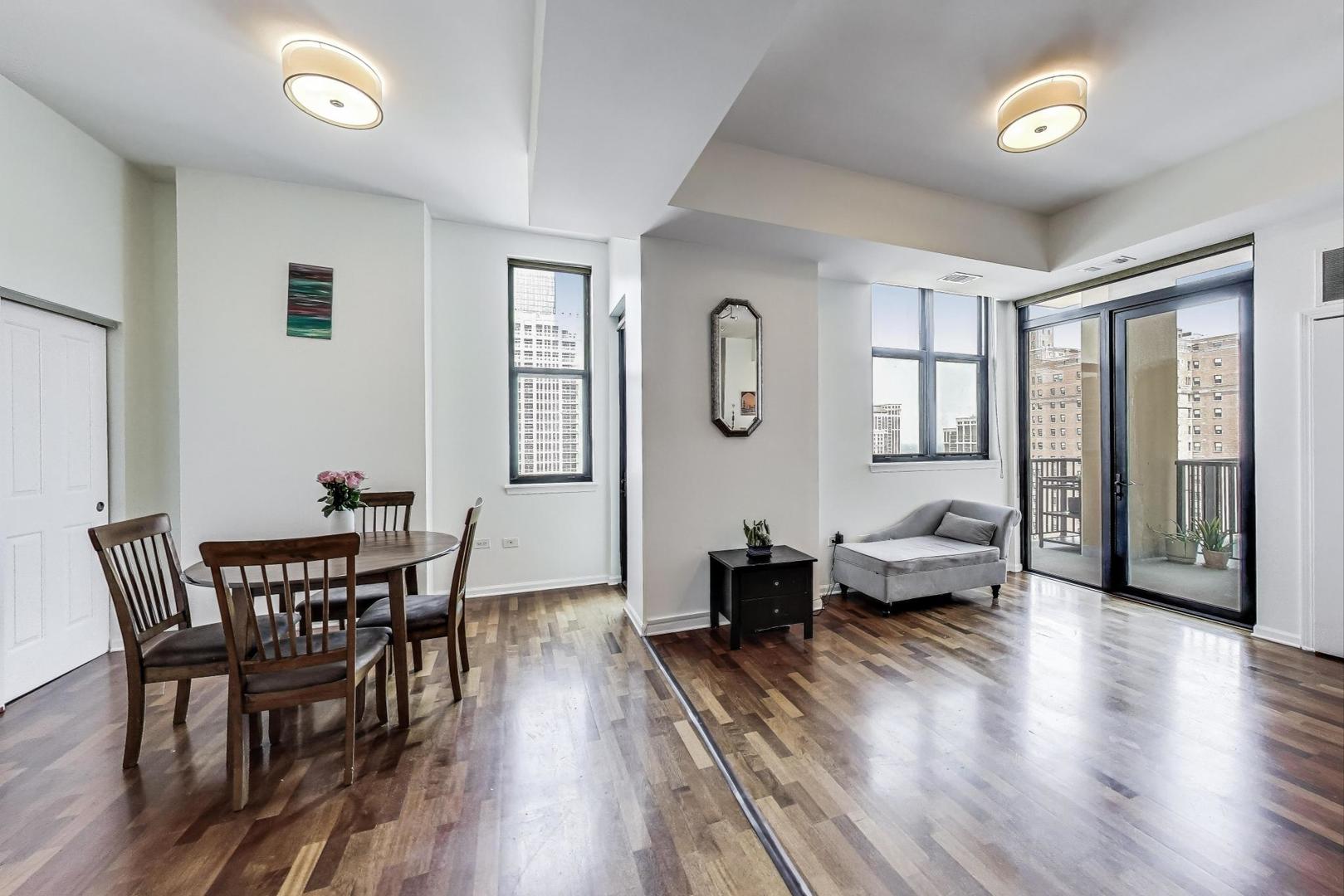 1464 South Michigan Avenue, Unit 1609 Chicago, IL 60605 - Photo 7 of 45 a living room with furniture and wooden floor