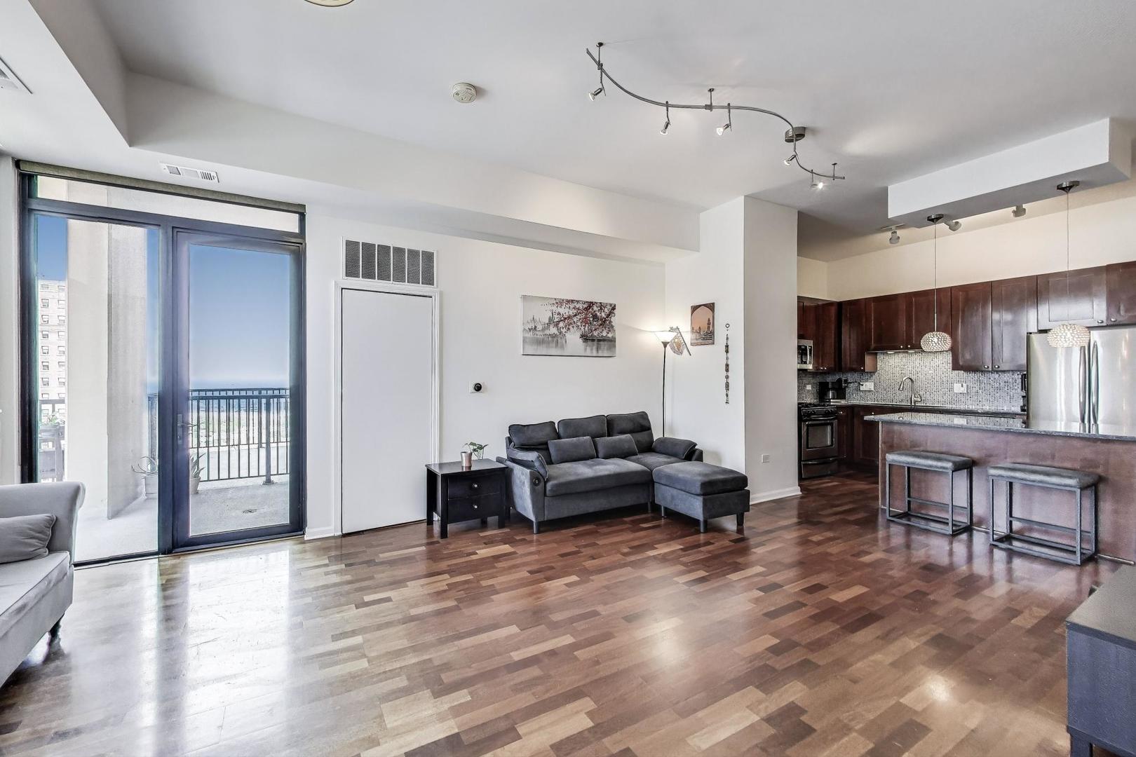 1464 South Michigan Avenue, Unit 1609 Chicago, IL 60605 - Photo 9 of 45 a living room with furniture and kitchen view