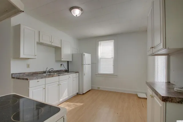 a kitchen with stainless steel appliances granite countertop a sink stove and cabinets
