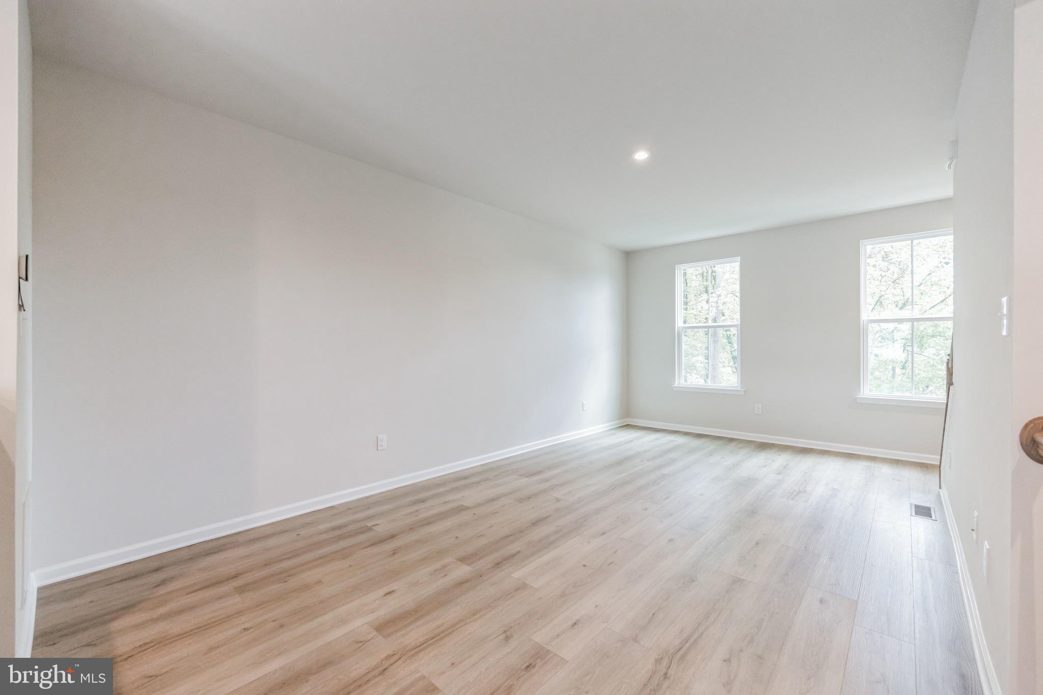 28 Sidney Lane Stratford, NJ 08084 - Photo 15 of 30 an empty room with wooden floor and windows