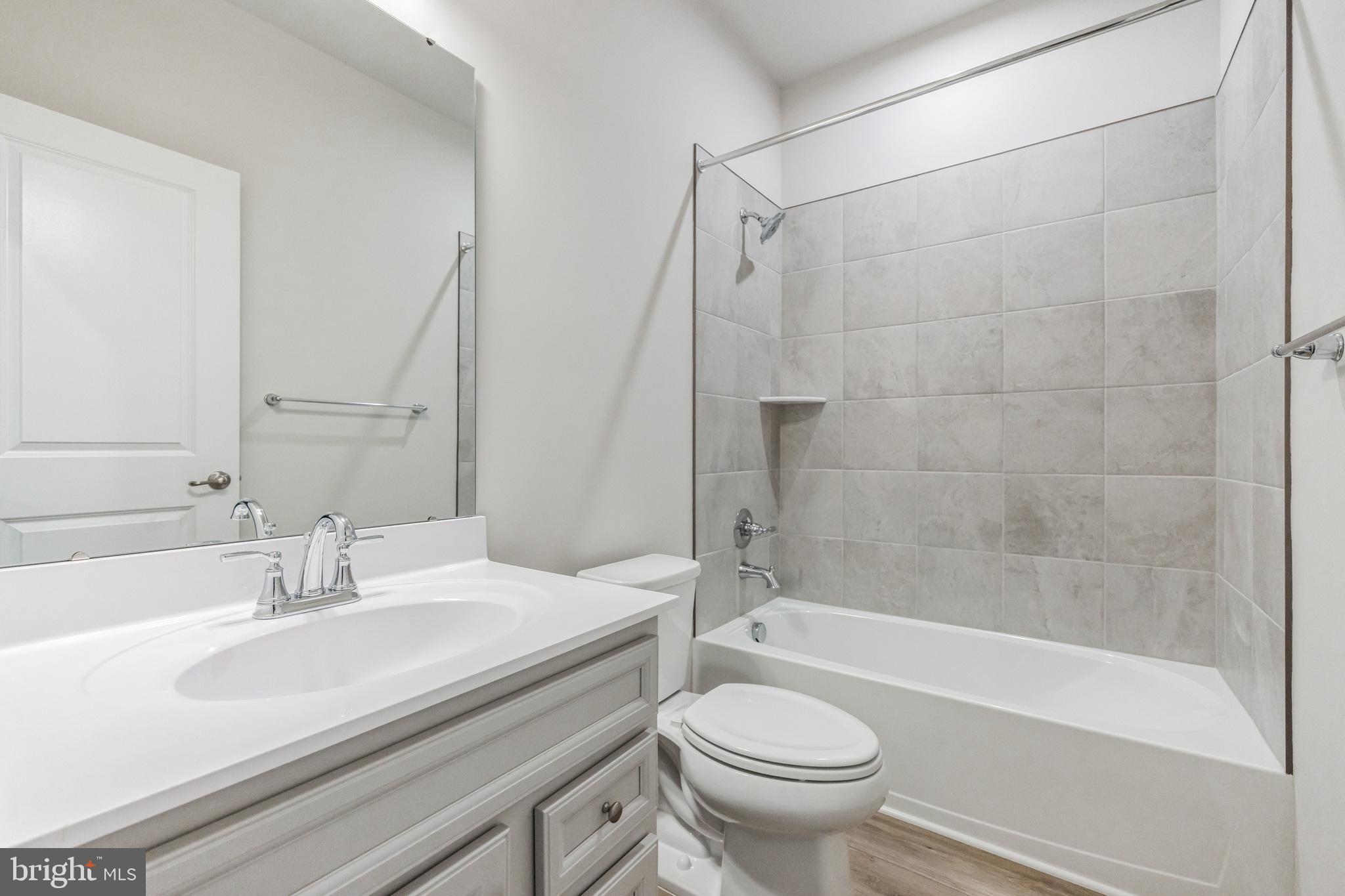 28 Sidney Lane Stratford, NJ 08084 - Photo 19 of 30 a bathroom with a sink a toilet and a bathtub