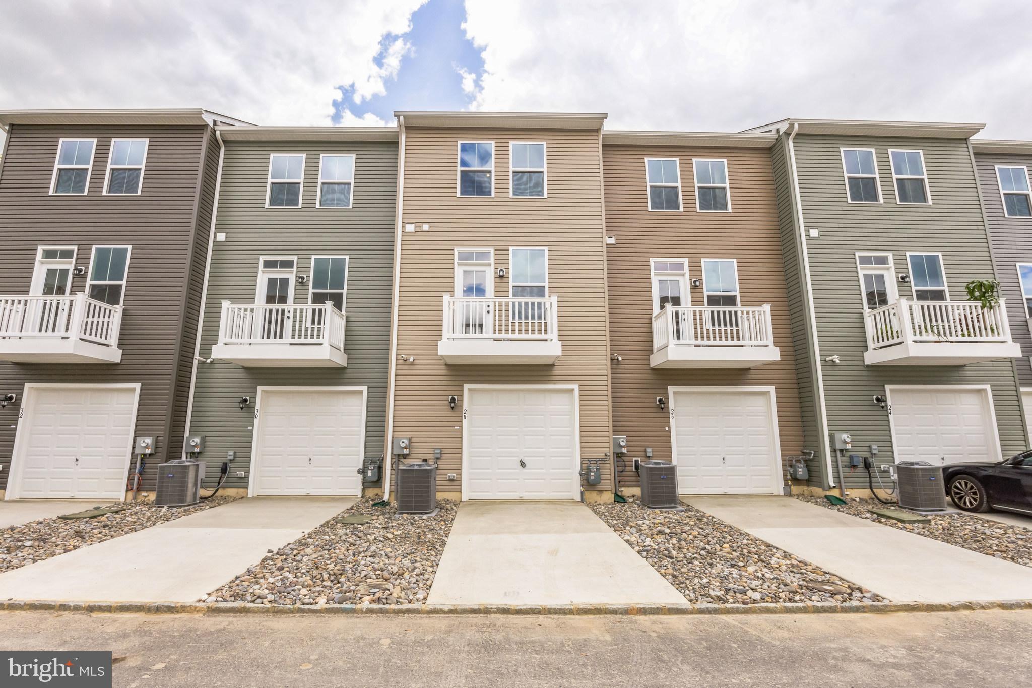 28 Sidney Lane Stratford, NJ 08084 - Photo 28 of 30 a front view of a house with a yard and garage