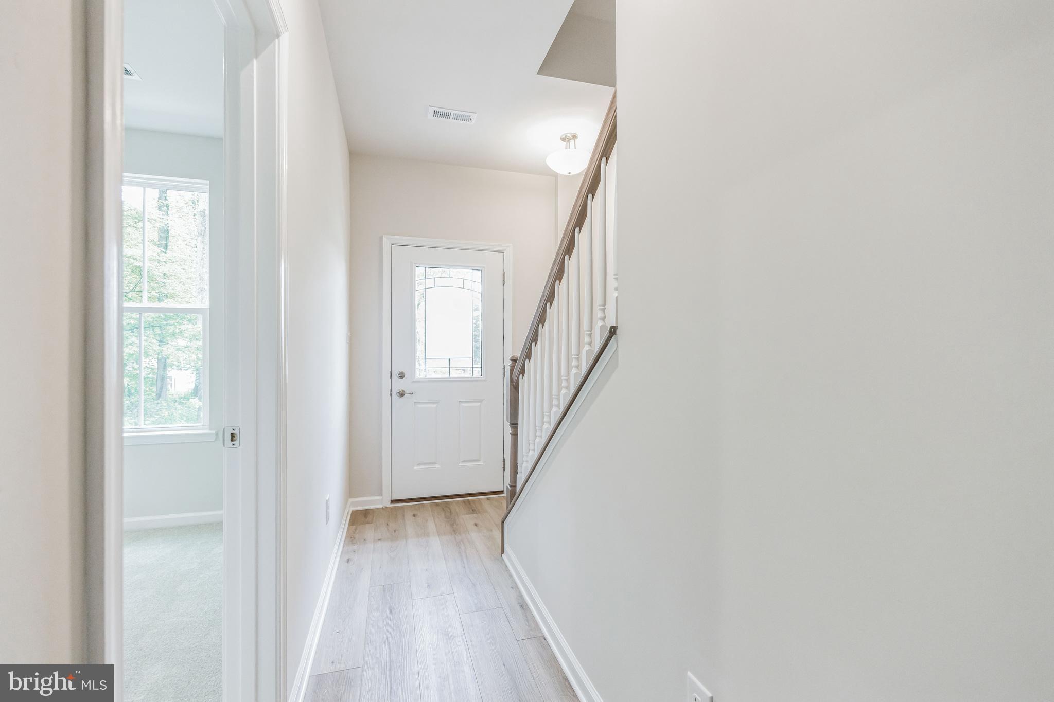 28 Sidney Lane Stratford, NJ 08084 - Photo 4 of 30 a view of a hallway with wooden floor and entryway