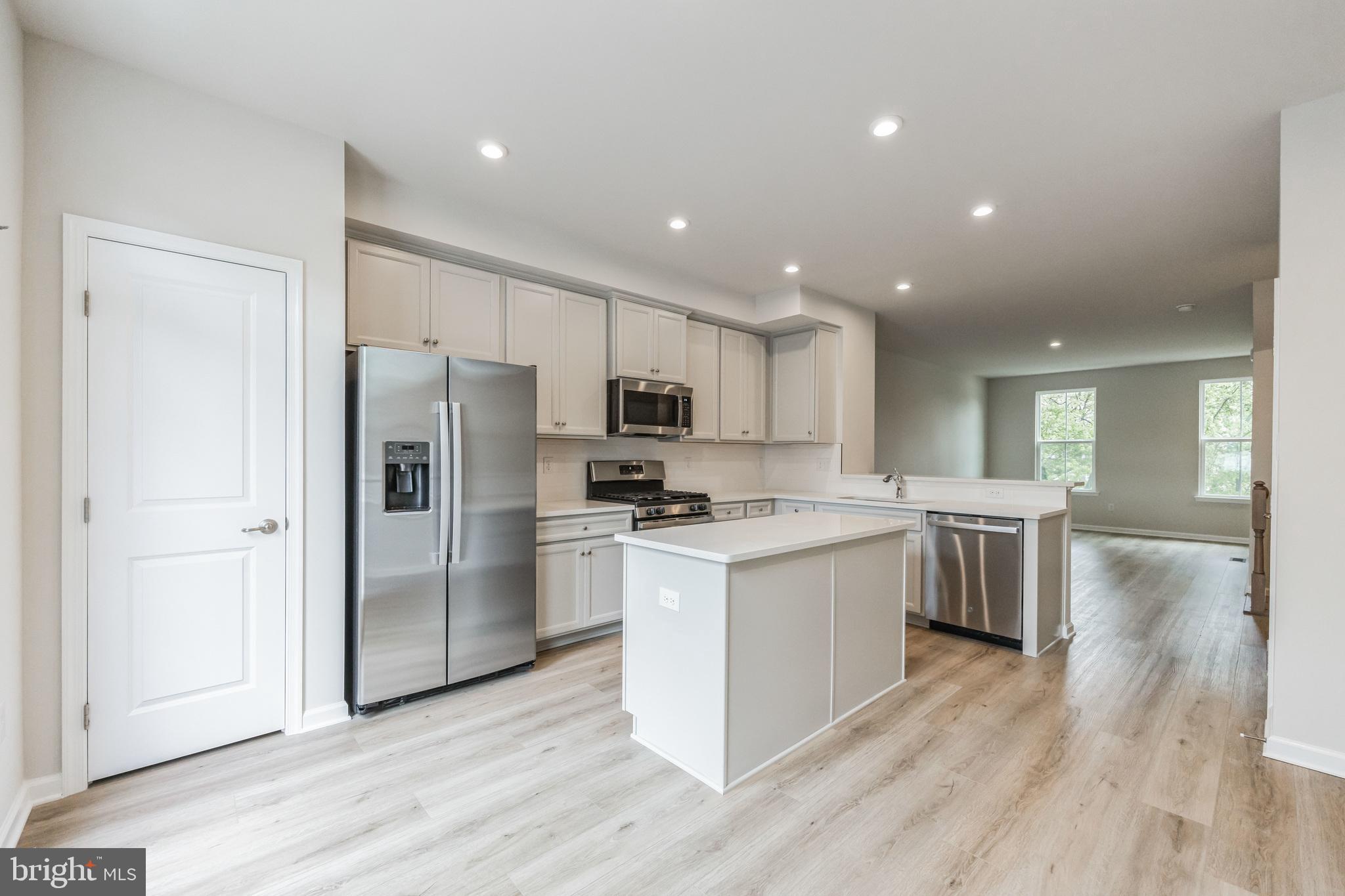 28 Sidney Lane Stratford, NJ 08084 - Photo 10 of 30 a kitchen with a refrigerator a sink and a stove top oven