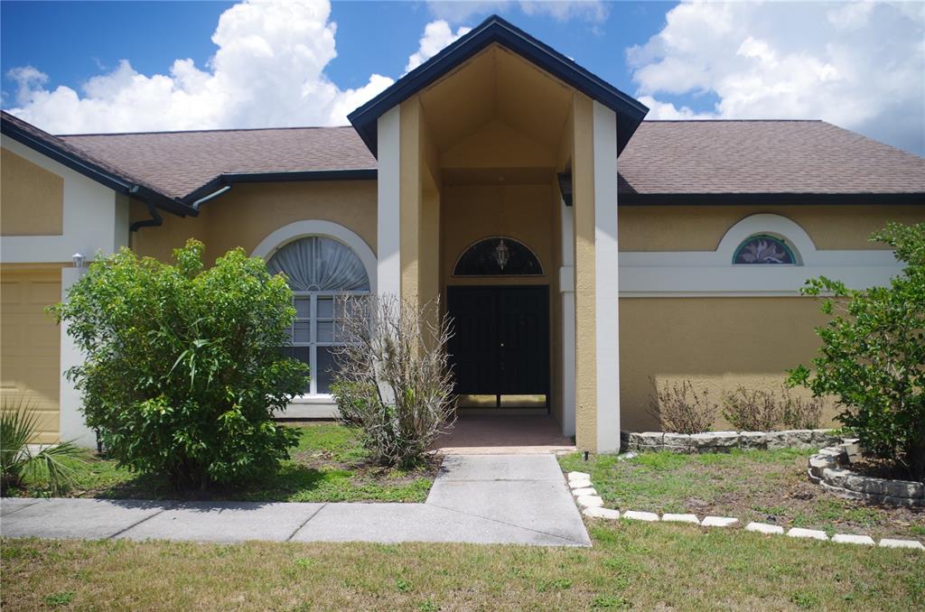 4207 Elba Place Valrico, FL 33596 - Photo 2 of 24 a front view of a house with garden