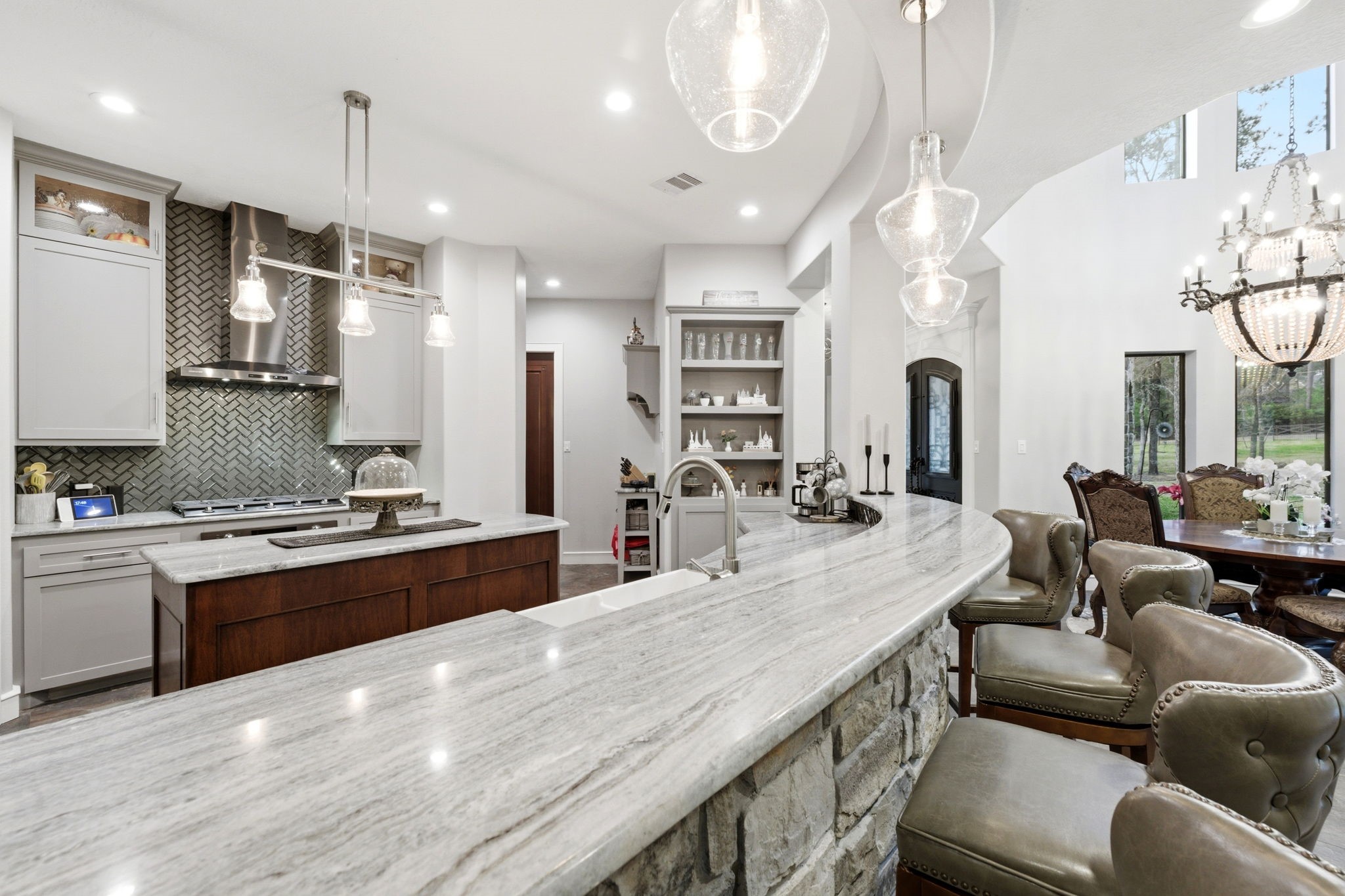 280 Sundog Road Huntsville, TX 77340 - Photo 15 of 50 Another angle highlights the distinctive granite countertops with beautiful gray movement, adding style and character to the kitchen design.