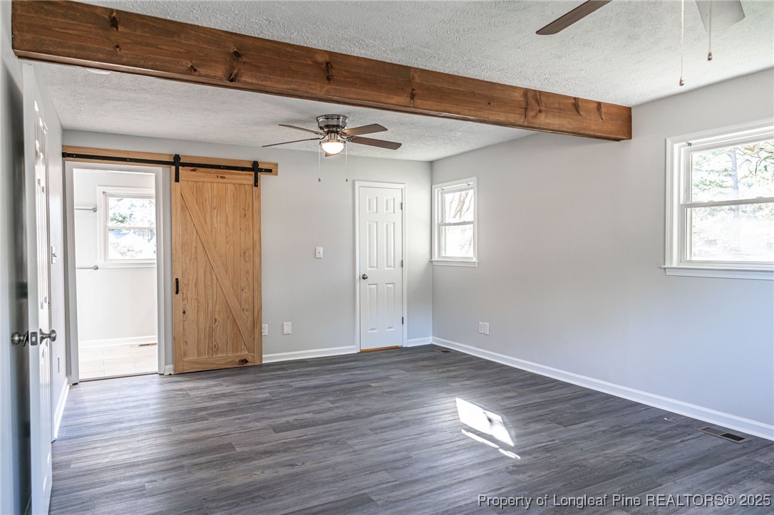 255 Foxcroft Road Whispering Pines, NC 28327 - Photo 22 of 31 a view of empty room with wooden floor and fan