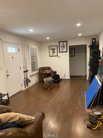 a living room with furniture gym equipment and a flat screen tv