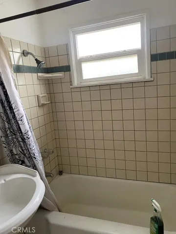 a bathroom with a bathtub and window