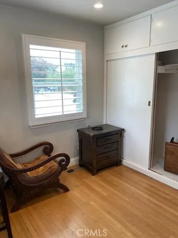 a room with a window and furniture