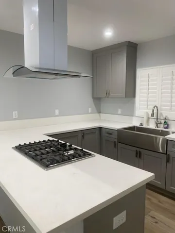a kitchen with a sink a stove and cabinets