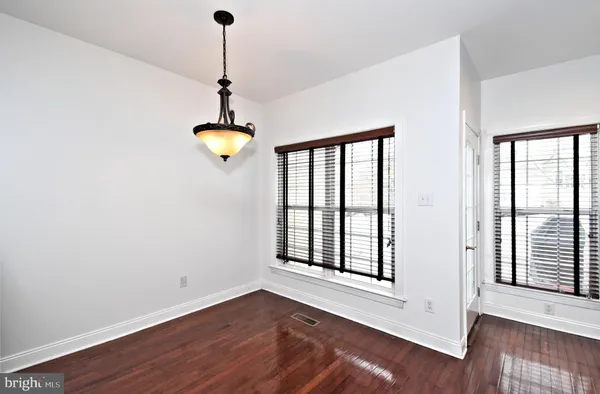 a view of an entryway with wooden floor and windows