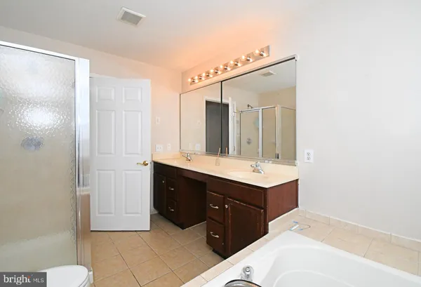 a bathroom with a sink vanity and mirror
