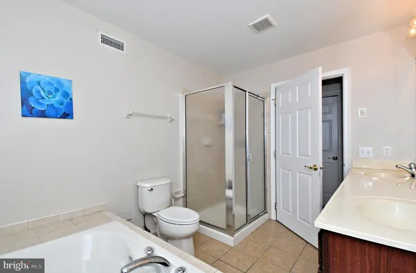 a bathroom with a toilet a sink and glass door