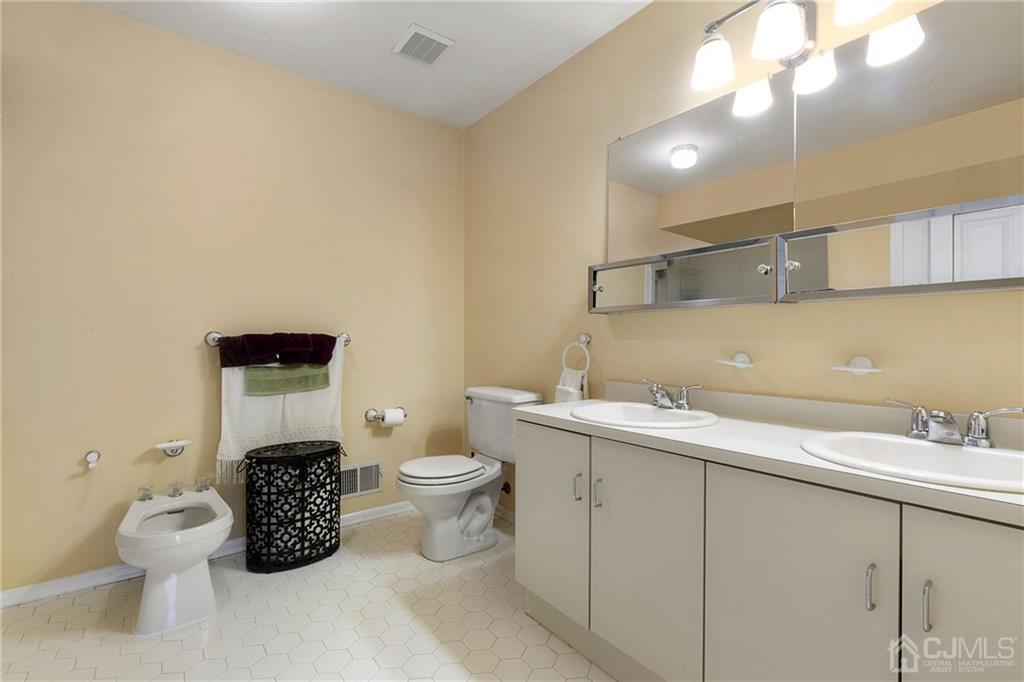 461 Cottrell Road Old Bridge, NJ 08857 - Photo 11 of 21 a bathroom with a toilet sink and mirror