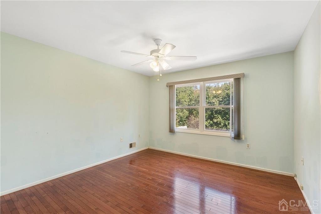 461 Cottrell Road Old Bridge, NJ 08857 - Photo 12 of 21 an empty room with a window and a ceiling fan