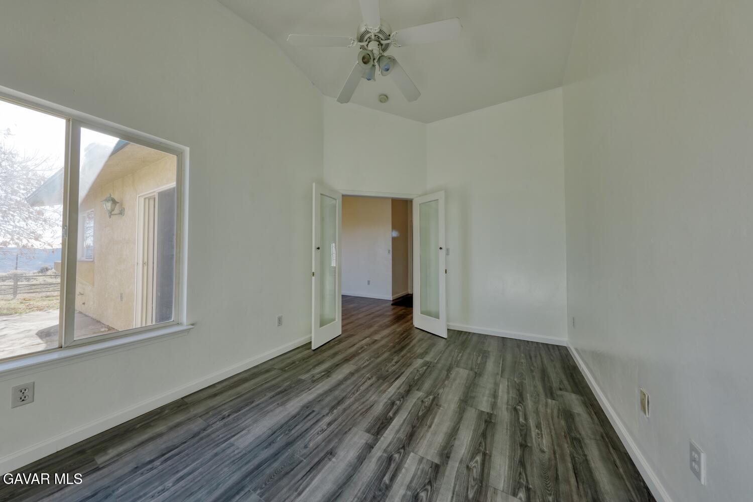 26801 Cabriolet Court Tehachapi, CA 93561 - Photo 19 of 60 a view of an empty room with wooden floor and a window