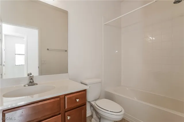 a bathroom with a sink toilet vanity and shower