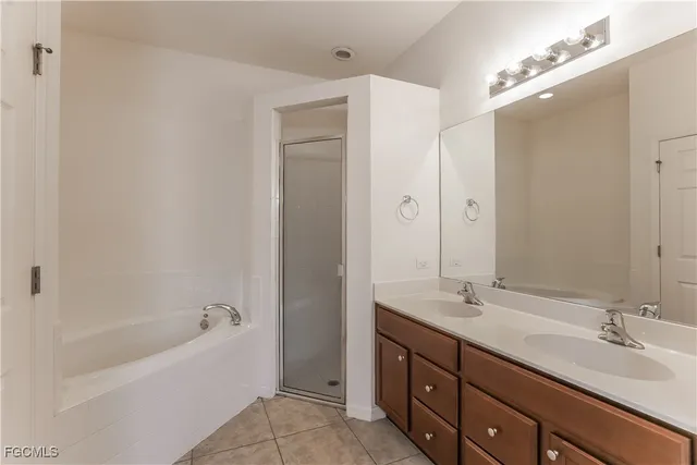 a bathroom with a tub sink and mirror