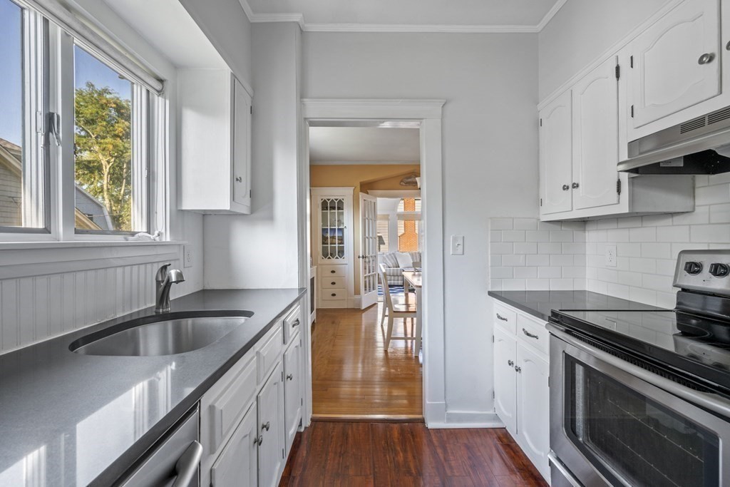 64 Farragut Road Swampscott, MA 01907 - Photo 14 of 35 a kitchen with a sink stove and cabinets
