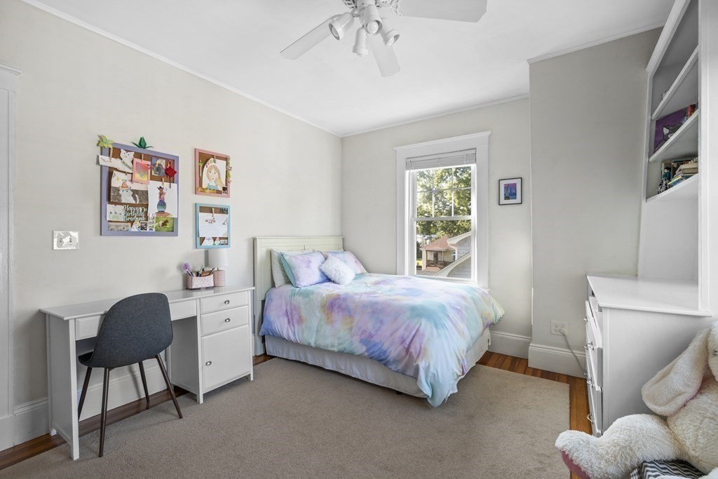 64 Farragut Road Swampscott, MA 01907 - Photo 23 of 35 a spacious bedroom with a bed and a chandelier