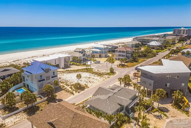 an aerial view of residential building and ocean view
