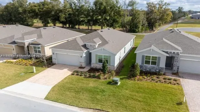a aerial view of a house with swimming pool next to a yard