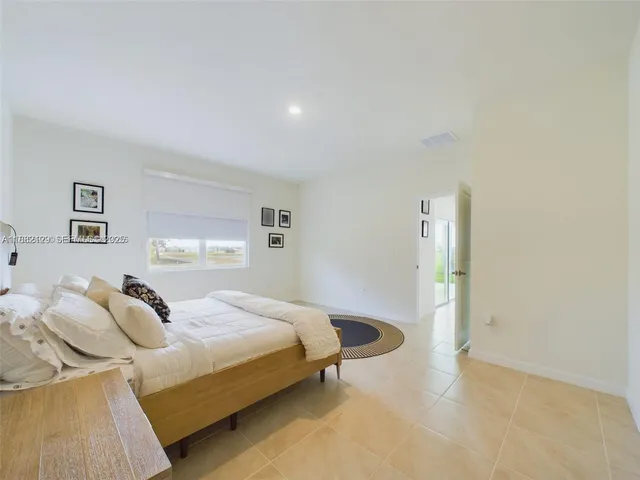 a bedroom with a bed and a table