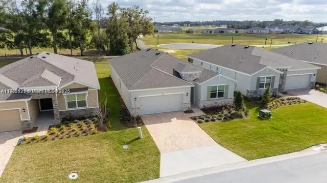 an aerial view of a house with swimming pool and outdoor space