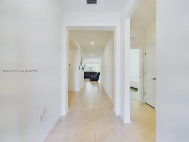 a view of a hallway with wooden shelves