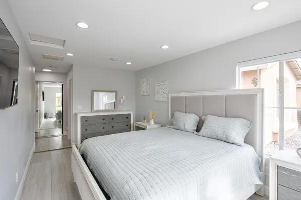 a bedroom with a bed and a window