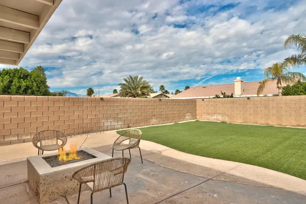 a view of a backyard with sitting area