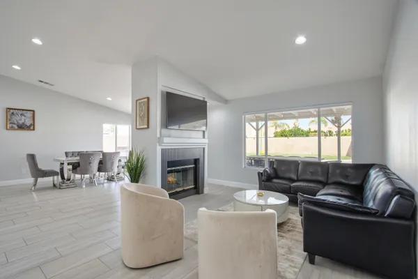 a living room with furniture flat screen tv and a fireplace