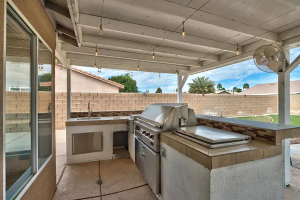 a backyard of a house with table and chairs