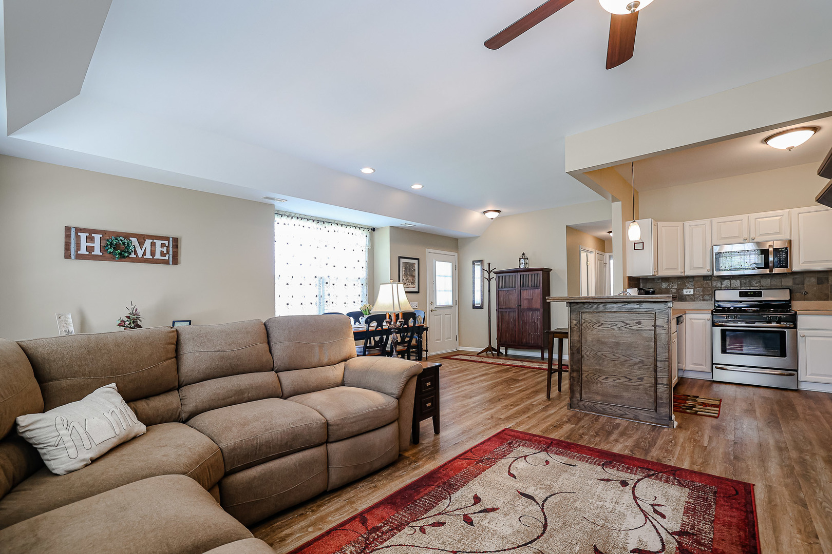 13553 Delaney Road Huntley, IL 60142 - Photo 8 of 29 a living room with furniture wooden floor and a kitchen view