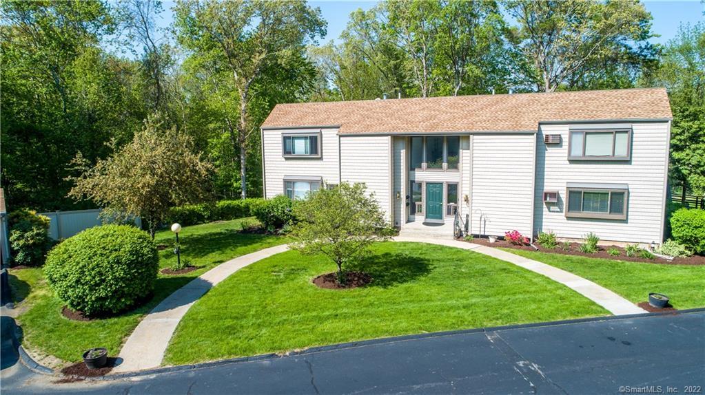 91 Riverview Road, Unit 8A East Lyme, CT 06357 - Photo 1 of 1 a view of a house with a yard and plants