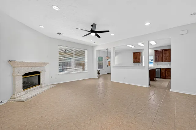 a view of a livingroom with a fireplace a sink and a living room